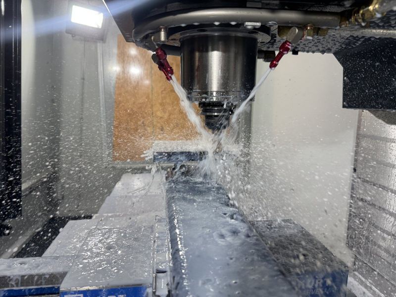 Flood coolant on a CNC mill roughing a part in our shop
