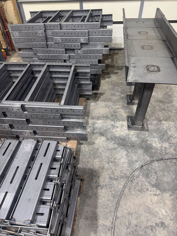 Welded steel frames and a stand on the shop floor